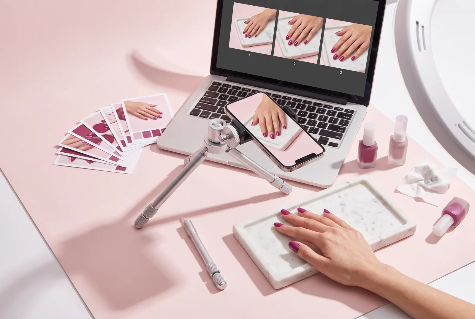 A printed photograph of plum-painted nails on a blush surface, with three cropped prints linked beside it